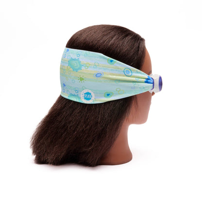 Mannequin head with a blue patterned headband and goggles on a white background• Splash Place sea glass swim goggles with blue and green fabric strap
• No tangle fabric strap swim goggles with blue tinted lenses and white frame