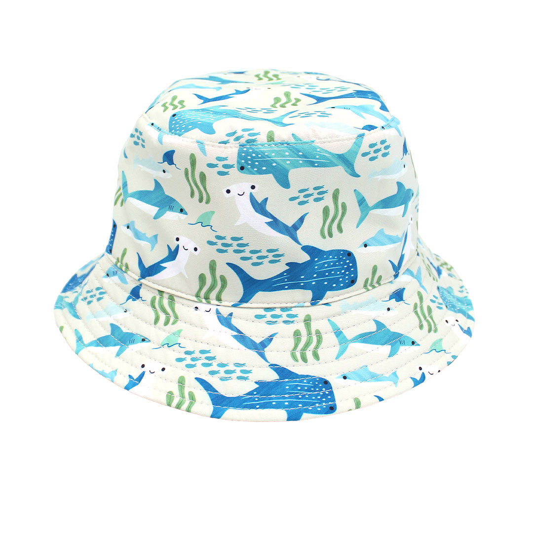 Flat lay picture of the Shark Friends & Ocean Blue Reversible Bucket Hat. The print features schools of fish, seaweed, and different types of sharks.