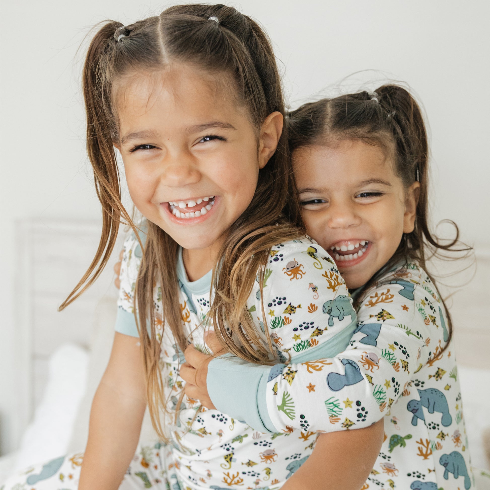 Close up of kids smiling in manatee bamboo pajamas soft breathable fabric for sensitive skin