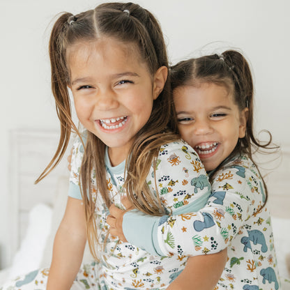 Close up of kids smiling in manatee bamboo pajamas soft breathable fabric for sensitive skin