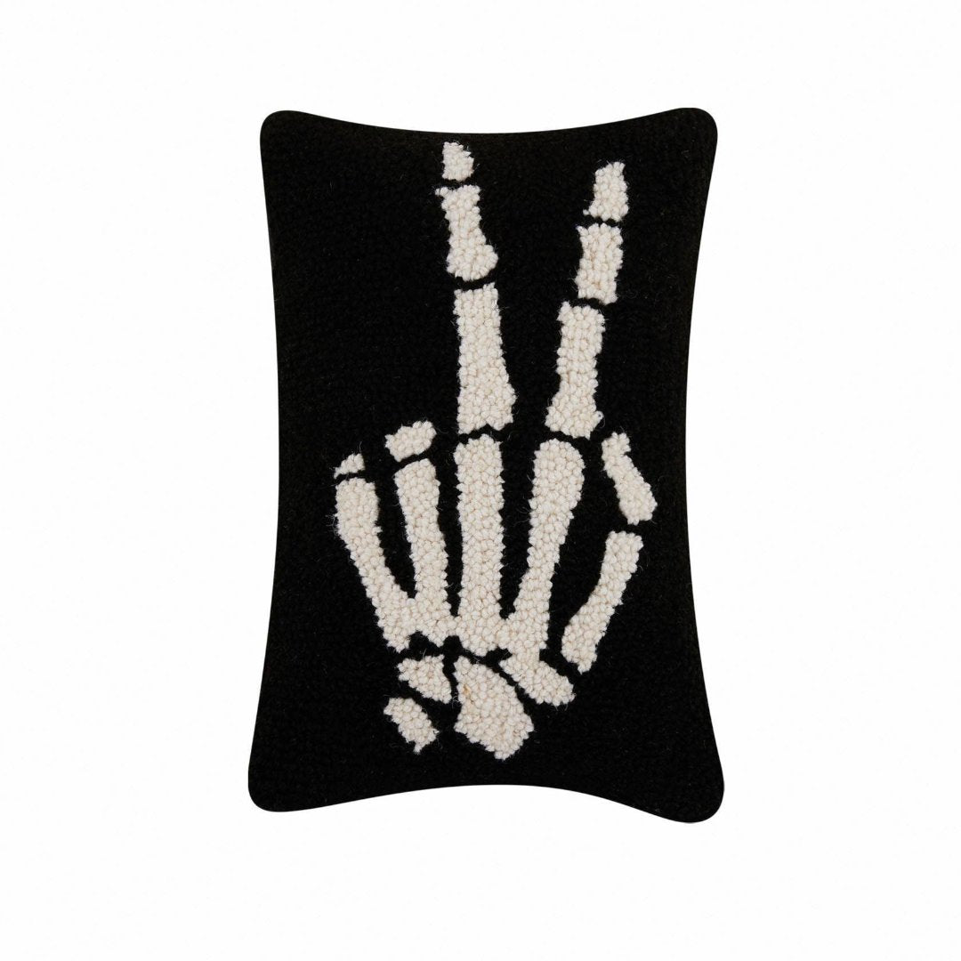 Black rectangle pillow with skeleton hand giving peace sign