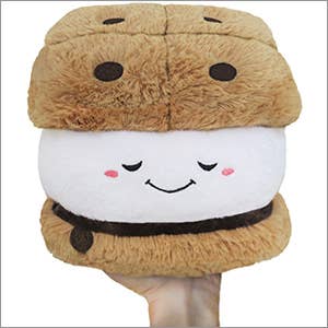 Plush toy resembling a marshmallow sandwich with a smiling face on a white background