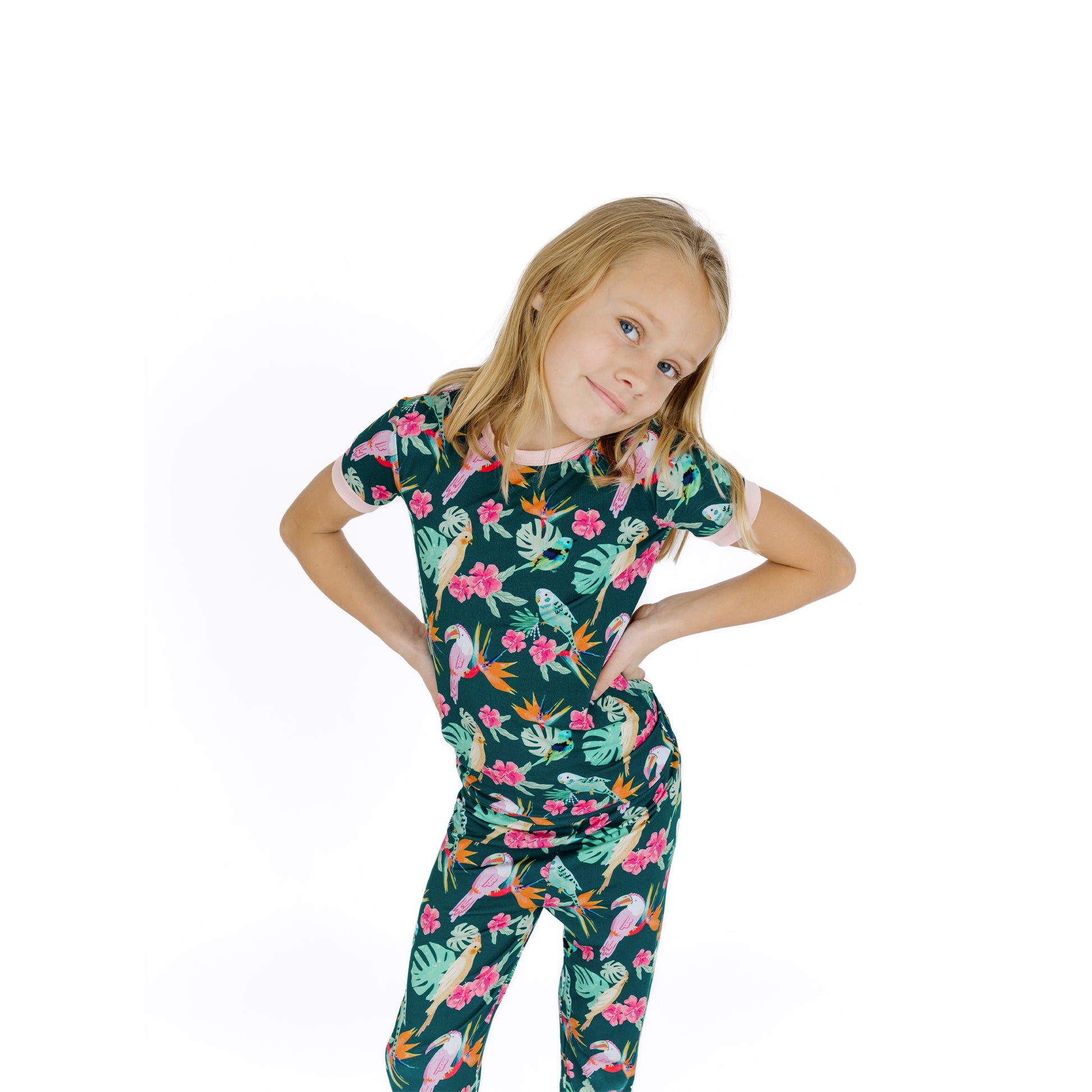 Girl modeling the Isla Botánica bamboo pajama set with pink trim, ideal for sensitive skin and slow weekend mornings.