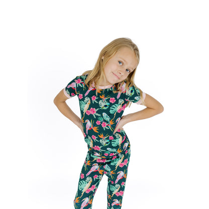 Girl modeling the Isla Botánica bamboo pajama set with pink trim, ideal for sensitive skin and slow weekend mornings.