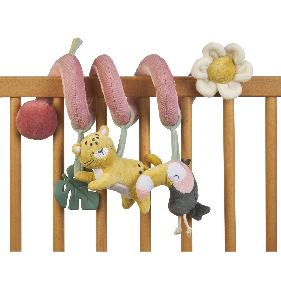 Baby crib mobile with hanging toys including a lion, mouse, and flowers on a wooden crib.