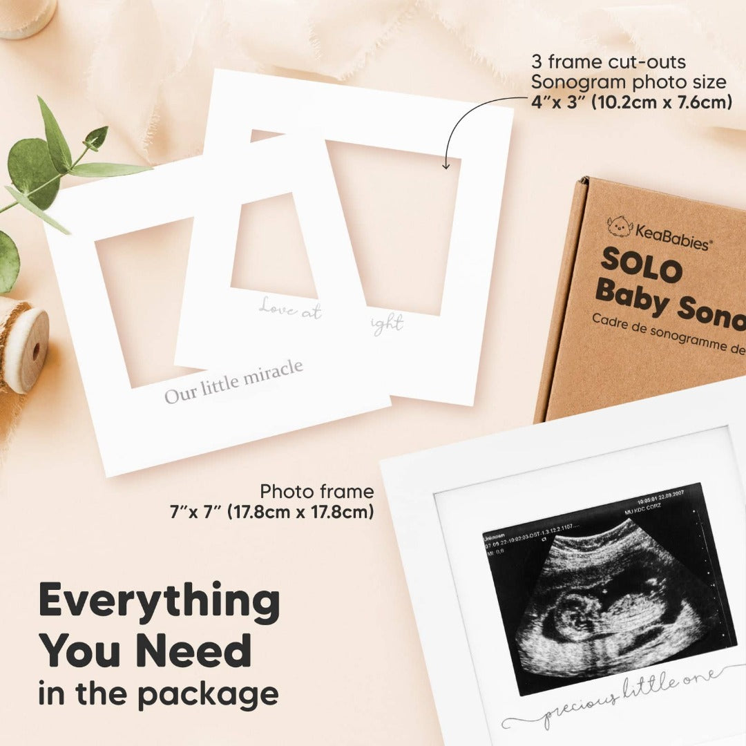 Ad for a white picture frame with text and a picture of a sonogram