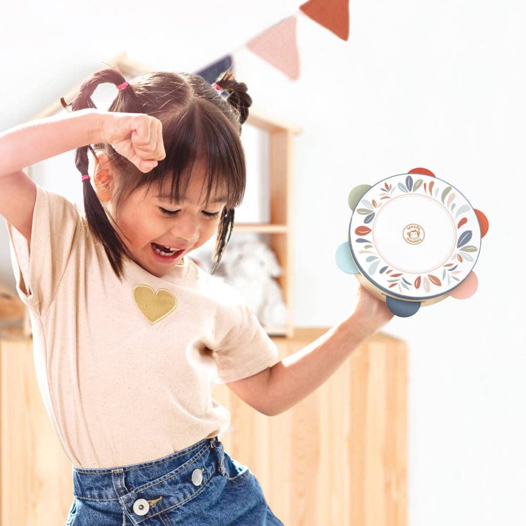 picture of a kid using the tambourine