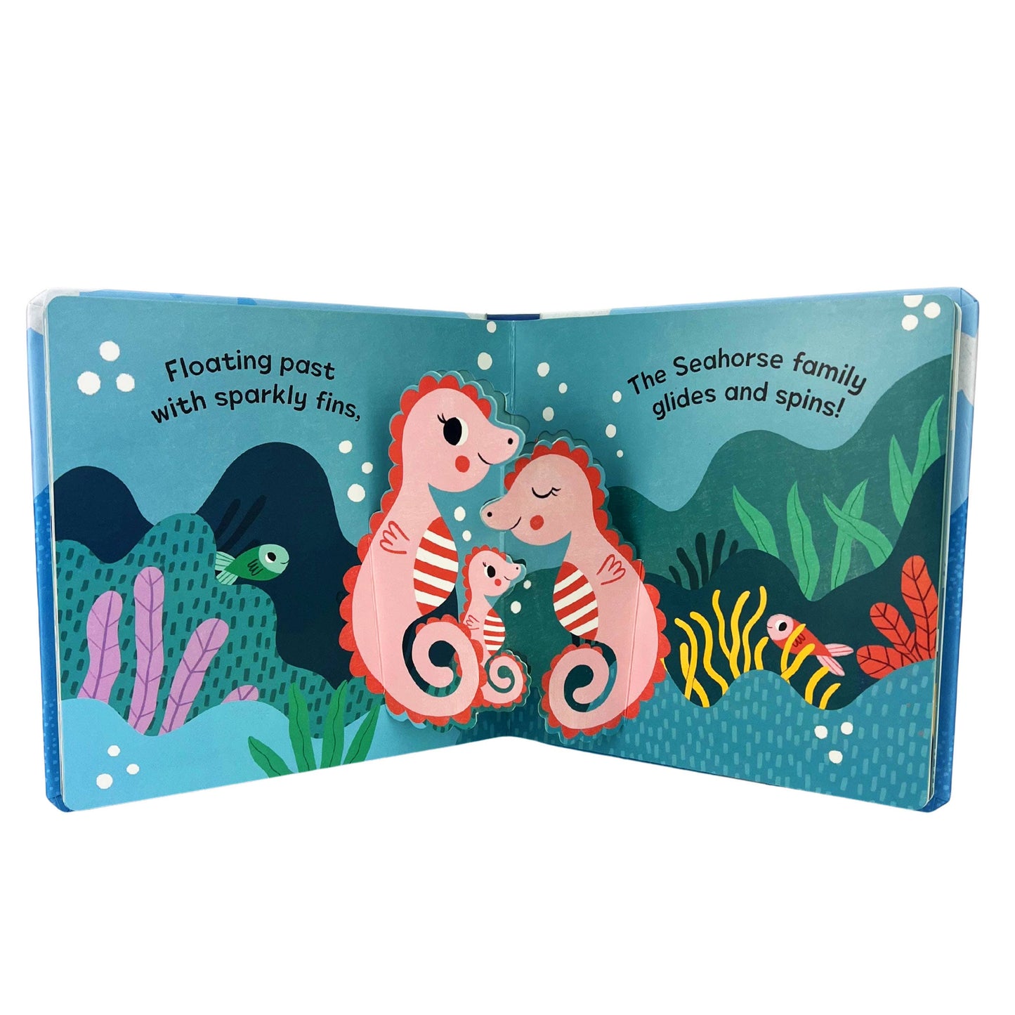 Illustrated book open to a page with seahorses and underwater scenery