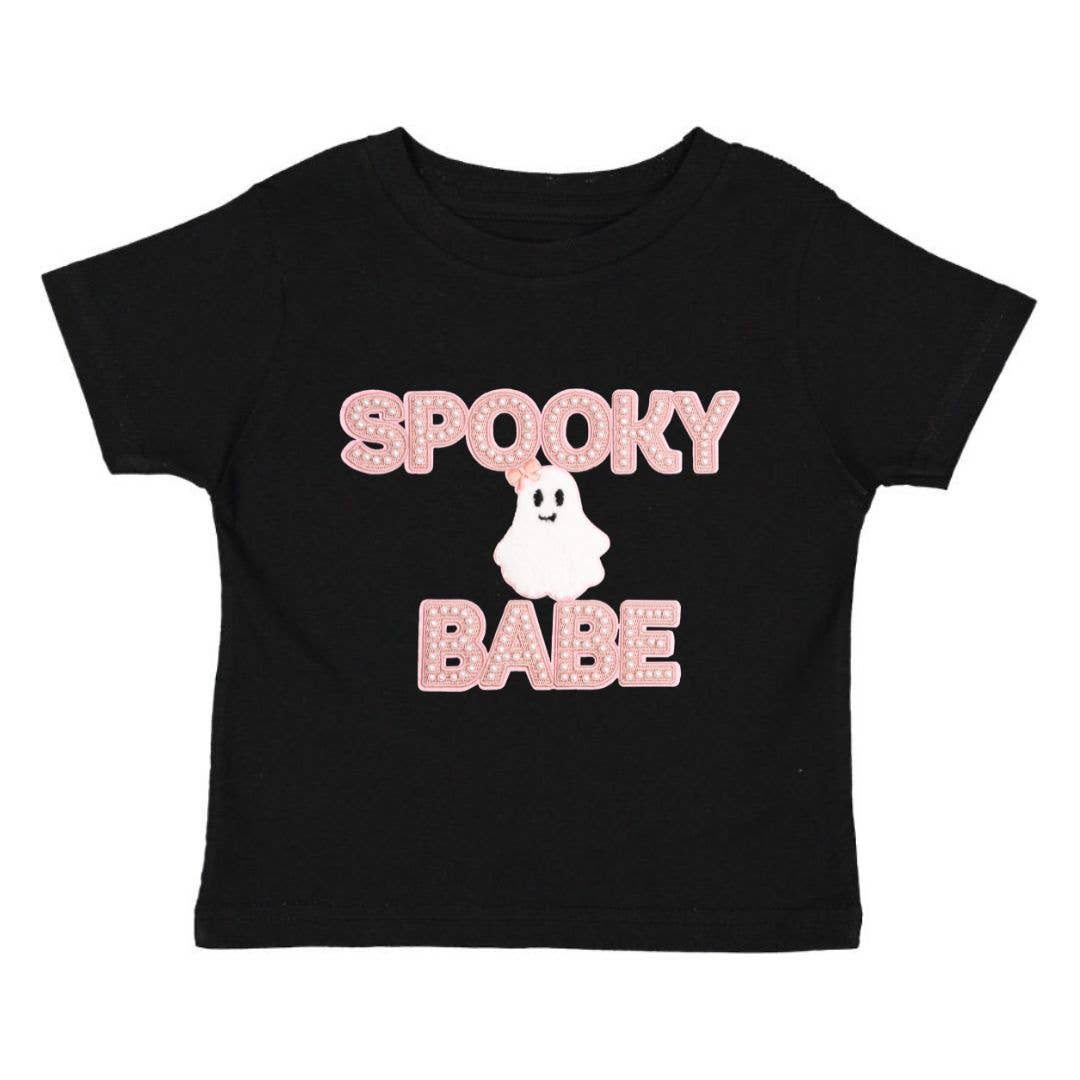 black shirt with spooky babe letters on the front in light pink and a white ghost