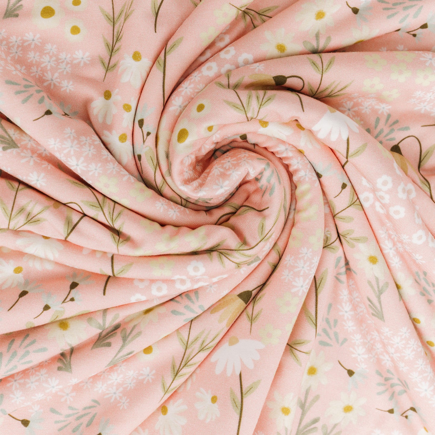 Roll of pink floral fabric with small flowers and leaves.