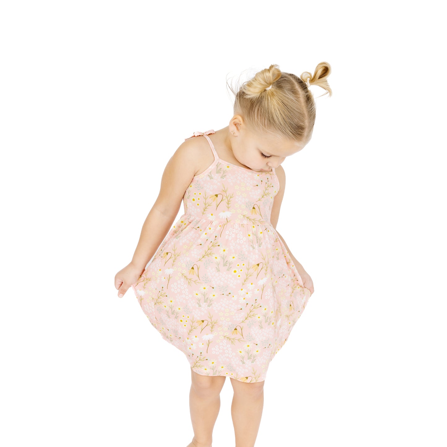 Young girl wearing a floral dress on a white background