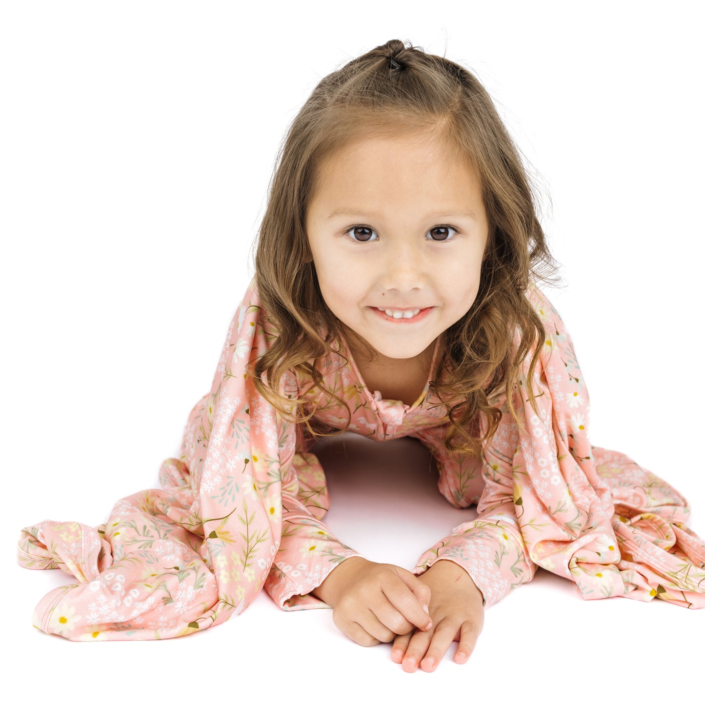 Young girl with a pink floral scarf on a white background