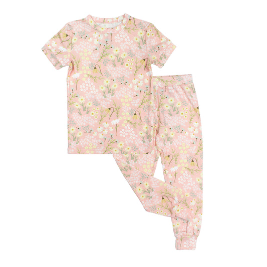 Children's pajama set with floral pattern on a white background