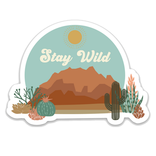 western and desert styled sticker that says "stay wild." you can see a canyon, rocks, and cacti. 