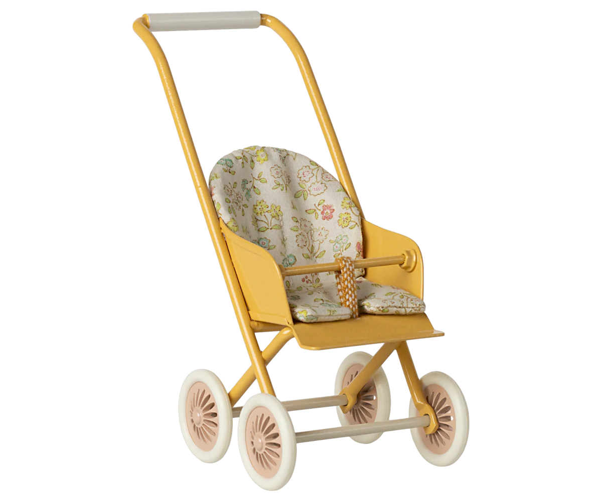 Yellow toy stroller with floral cushion on a white background