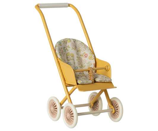 Yellow toy stroller with floral cushion on a white background
