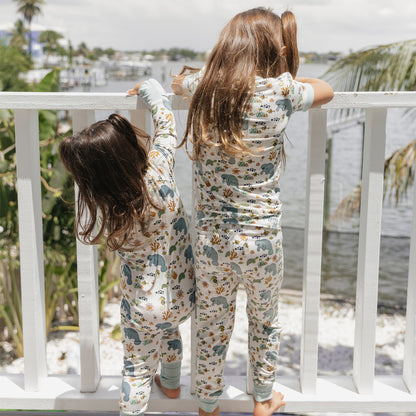 Back view of kids wearing manatee bamboo pajamas outdoors showing ocean print design