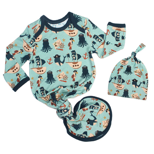 the "pirate's life" gown and hat matching set. the "pirate's life" print is a mix of octopus, whales, and seagulls all wearing pirate hats. there are also anchors, pirate ships, treasure maps, and starfish mixed into the pattern. this is all displayed on a teal background. 