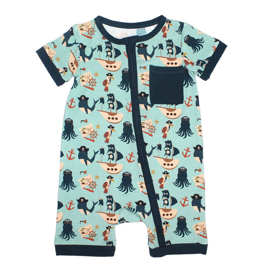 the "pirate's life" shortie romper. the "pirate's life" print is a mix of octopus, whales, and seagulls all wearing pirate hats. there are also anchors, pirate ships, treasure maps, and starfish mixed into the pattern. this is all displayed on a teal background. this shortie has a navy blue outline and pocket. 