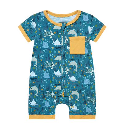 the "ocean friends" bamboo baby boy shortie. the "ocean friends" print is a combination of dolphins, stingrays, fish, starfish, coral, bubbles, and sharks, all spread out on a deep sea blue background. 
