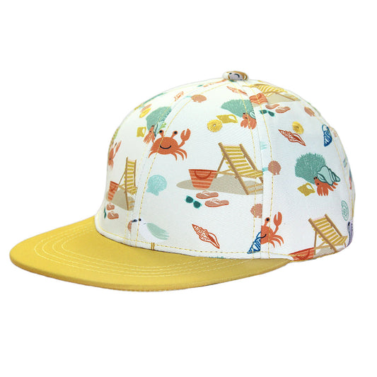 the "beach days" snapback hat. its the "beach days" print on the bowl of the hat and a yellow lip of the hat. the "beach days" print is a scattered print of beach umbrellas, beach balls, sand buckets and shovels, coral, shells, beach chairs, seagulls, flipflops, and sunglass mixed in a orderly and creative way. 