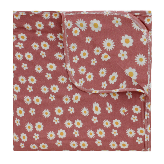 the "rose daisy" bamboo luxury blanket. the "rose daisy" print are daisy flowers on a rose pink background. 