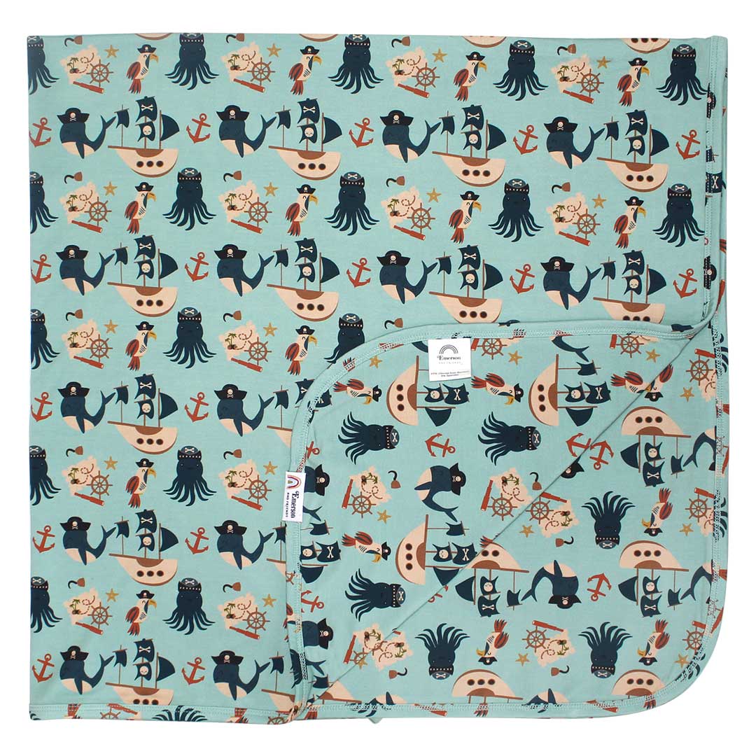 the "pirate's life" bamboo blanket. the "pirate's life" print is a mix of octopus, whales, and seagulls all wearing pirate hats. there are also anchors, pirate ships, treasure maps, and starfish mixed into the pattern. this is all displayed on a teal background. 