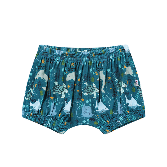 the "ocean friends" bamboo baby bloomers. the "ocean friends" print is a combination of dolphins, stingrays, fish, starfish, coral, bubbles, and sharks, all spread out on a deep sea blue background. 
