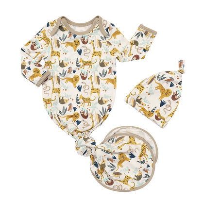the "jungle friends" gown and hat matching set. the gown ties in a knot at the bottom. the "jungle friends" print is a mix of jungle animals that include giraffes, lions, cheetahs, sloths, snakes, and forest plants. 