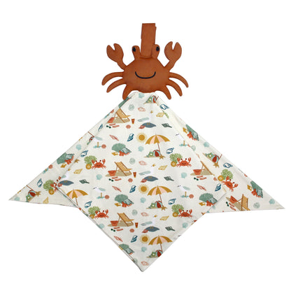 the "beach days" lovey. the blanket part of it is in the print "beach days." there is a crab on the top. the "beach days" print is a scattered print of beach umbrellas, beach balls, sand buckets and shovels, coral, shells, beach chairs, seagulls, flipflops, and sunglass mixed in a orderly and creative way. 
