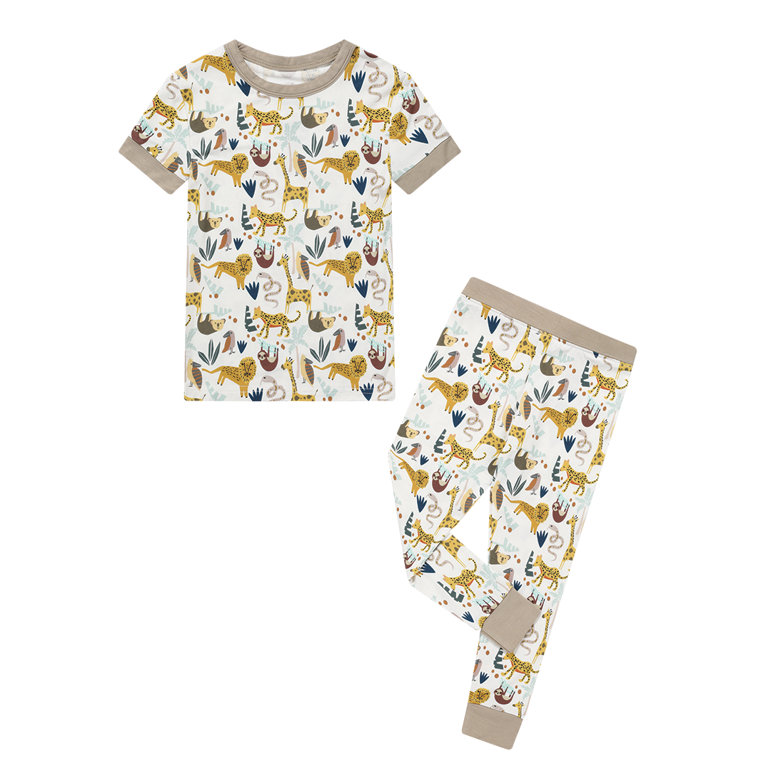 the "jungle friends" matching pajama set. the "jungle friends" print is a mix of jungle animals that include giraffes, lions, cheetahs, sloths, snakes, and forest plants. 