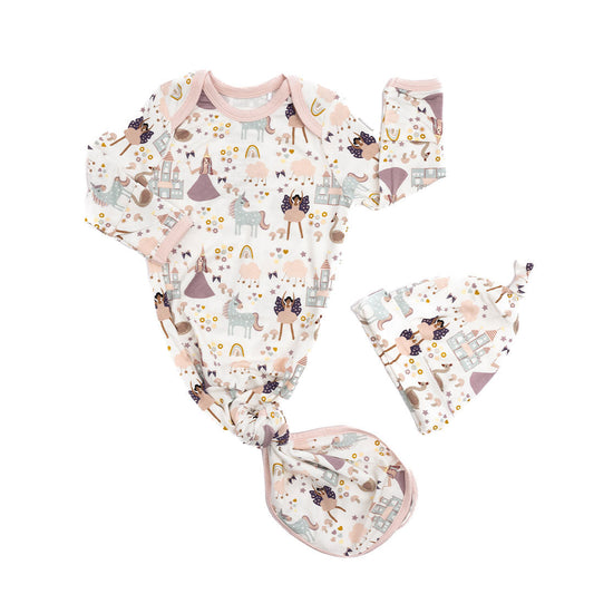 the "once upon a time" matching hat and gown infant set. the "once upon a time" print is a mix of pinks, purples, whites, blues, and yellows. you can see fairy princess and regular princess, unicorns, swans, and castles. theres also hearts, stars and sparkles scattered around the print. 