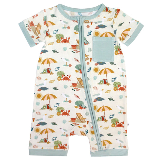 the "beach days" shortie romper. the "beach days" print is a scattered print of beach umbrellas, beach balls, sand buckets and shovels, coral, shells, beach chairs, seagulls, flipflops, and sunglass mixed in a orderly and creative way. 