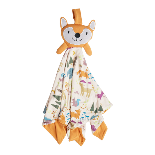 the "forest friends" lovey is a blanket with the "forest friends" print with an orange fox face attached to the top of it. the "forest friends" print has a mix of red foxes, brown deer, blue bears, purple bunnies, trees, grass, mushrooms, acorns, moons, and other colored dots scattered over a white background. 