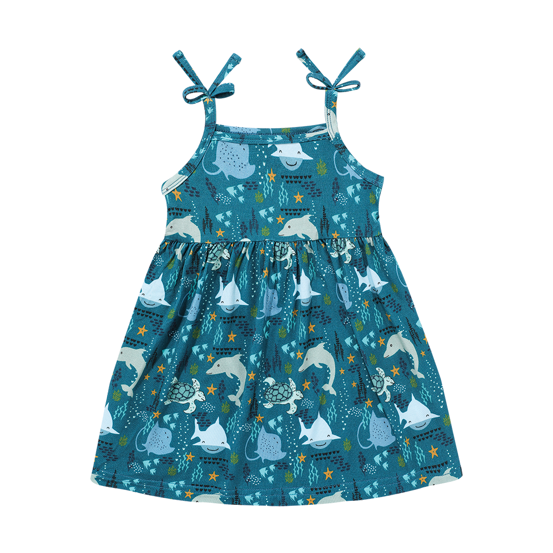 the "ocean friends" bamboo sundress. the "ocean friends" print is a combination of dolphins, stingrays, fish, starfish, coral, bubbles, and sharks, all spread out on a deep sea blue background. 