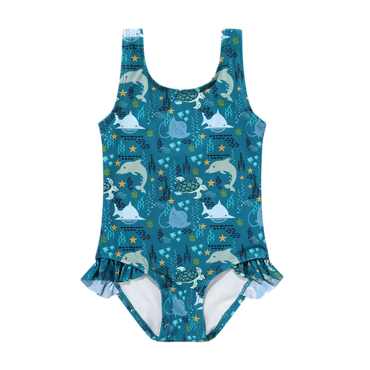 the "ocean friends" ruffled legged one piece swimsuit. the "ocean friends" print is a combination of dolphins, stingrays, fish, starfish, coral, bubbles, and sharks, all spread out on a deep sea blue background. 