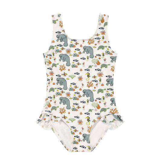 the "manatee" ruffle legged one piece girls swimsuit. the print "manatee" unites the florida sea life in a majestic print. there is a variation of florida manatees, yellow and pink sea horses, yellow and pink starfish, bubbles, turtles, and coral patterned across a white background