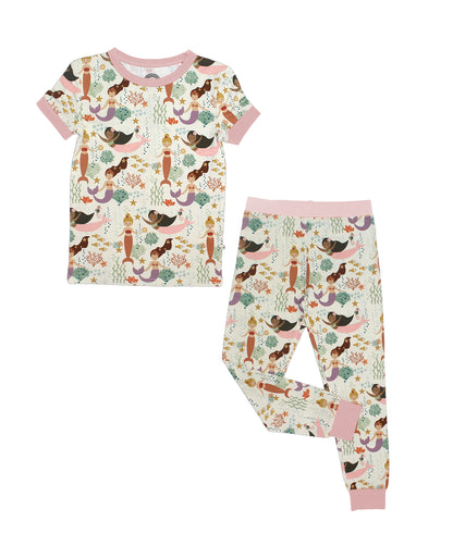 the "making waves" short sleeved 2-piece pajama set. the "making waves" print has a diverse spread of mermaids, sea coral, starfish, fish, and bubbles all spread out in different colors. this is all put on a beige background.