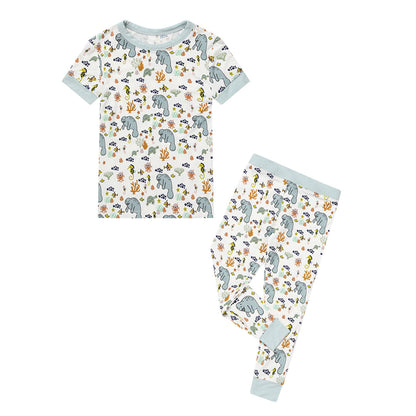 the "manatee" 2-piece matching pajama set. the print "manatee" unites the florida sea life in a majestic print. there is a variation of florida manatees, yellow and pink sea horses, yellow and pink starfish, bubbles, turtles, and coral patterned across a white background