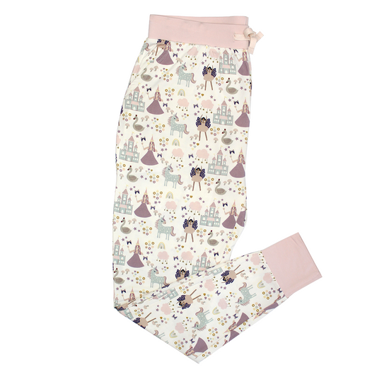 the "once upon a time" women's joggerpants. the "once upon a time" print is a mix of pinks, purples, whites, blues, and yellows. you can see fairy princess and regular princess, unicorns, swans, and castles. theres also hearts, stars and sparkles scattered around the print. 