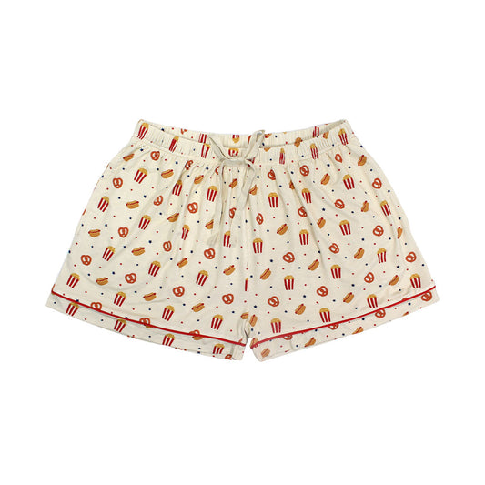 the "here for the snacks" bamboo women's shorts. the "here for the snacks" print has a variation of pretzels, hotdogs, popcorn, and blue and red stars scattered around a beige background. 