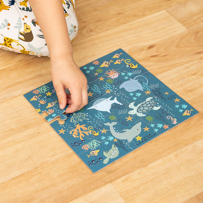 a hand puts together the "ocean friends" puzzle. 