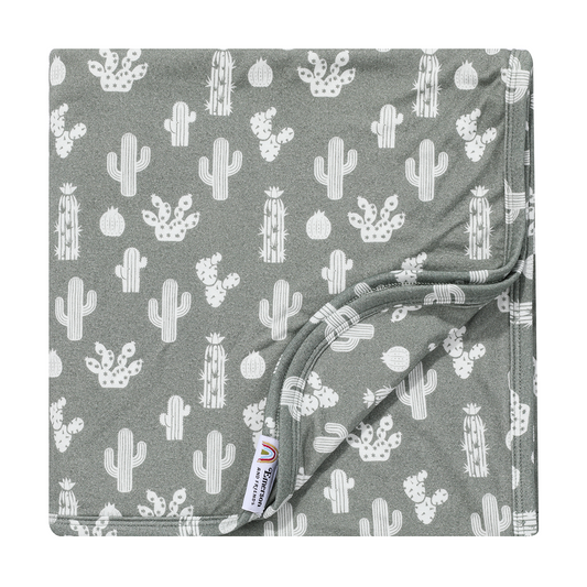 the "stay sharp" bamboo blanket. the "stay sharp" print is a variety of different white cacti on a greyish/green background. 