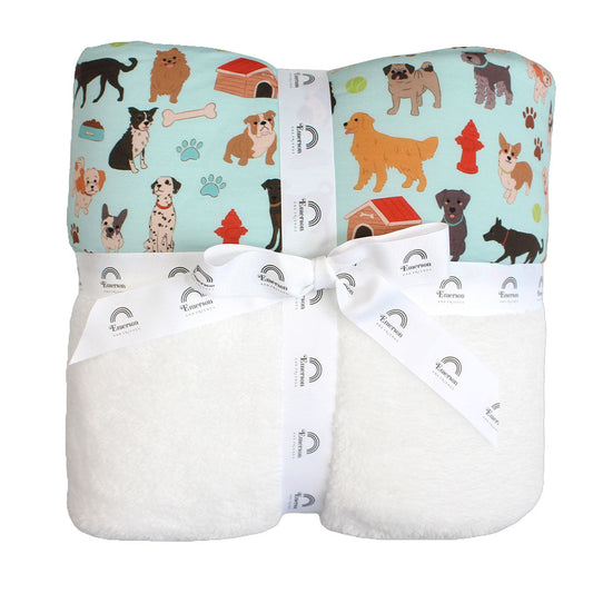 the "dogs bark" bamboo fleece blanket. the "dogs bark" print is a mix of various types of dogs, dog houses, dog bones, paw prints, dog food, and tennis balls scattered around a light blue background.