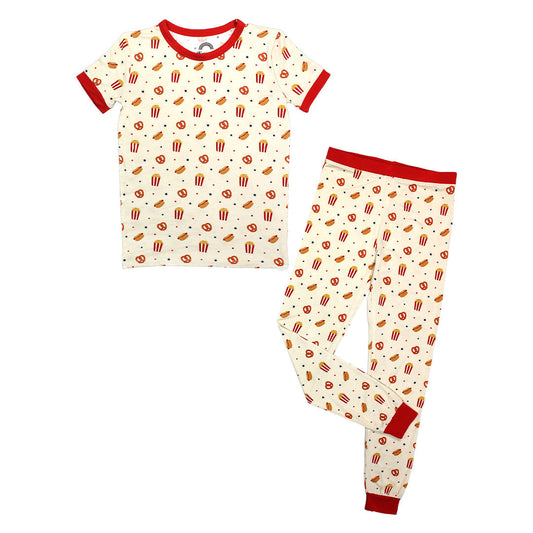 the "here for the snacks" 2-piece matching set. the "here for the snacks" print has a variation of pretzels, hotdogs, popcorn, and blue and red stars scattered around a beige background. 
