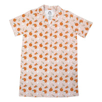 the "freshly squeezed" bamboo nightgown. the "freshly squeezed" print has an assortment of full and half cut oranges scattered around. there is also flower heads and flower stems that intermingle within the print. this is all space out around a pink background space. 