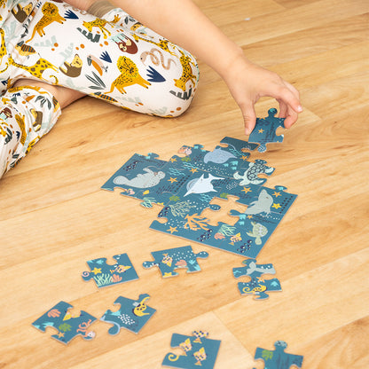 a hand puts together the "ocean friends" puzzle. 