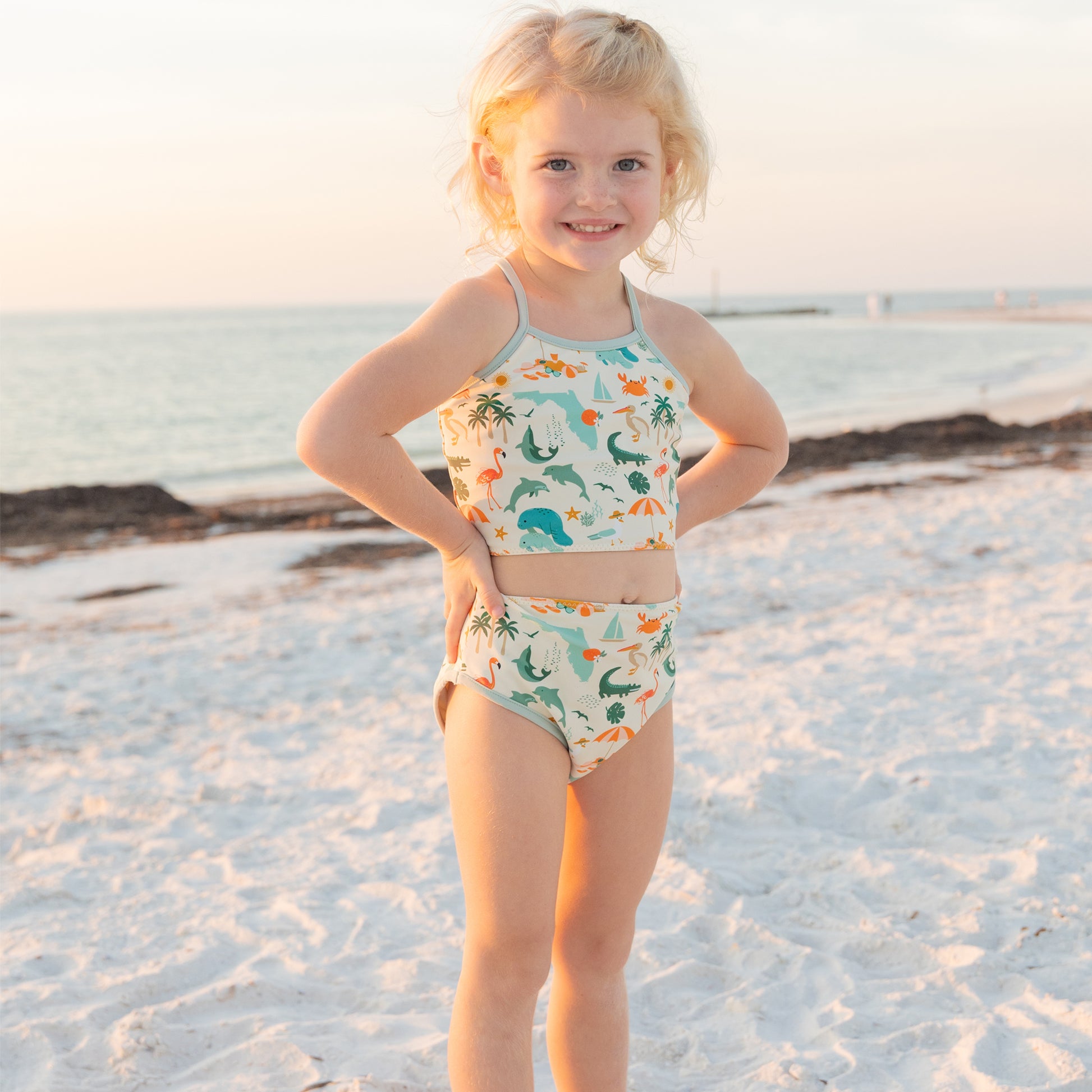 Full view of a girl in the Explore Florida bikini set, which offers UPF 50+ protection for all-day beach play.