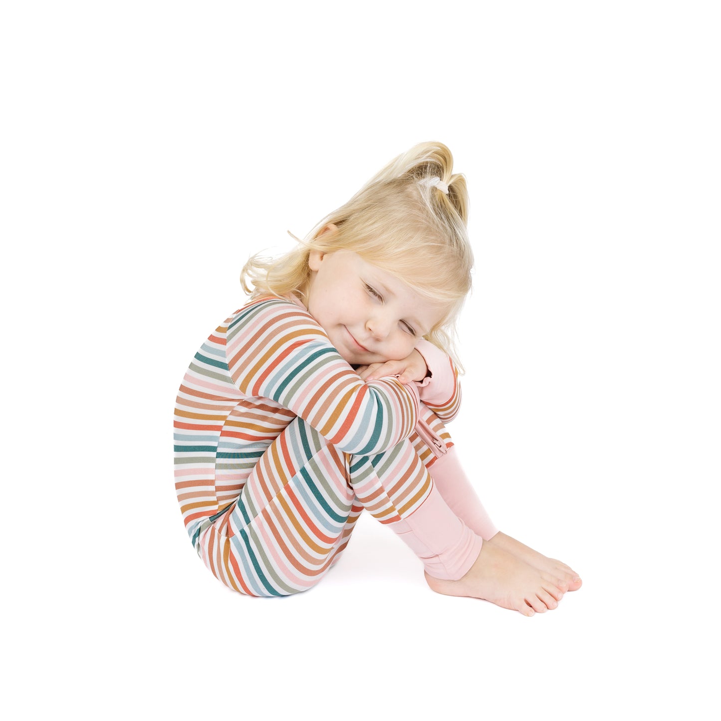 Child wearing a colorful striped outfit on a white background