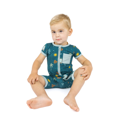 Baby sitting in Surf’s Up bamboo shortie romper